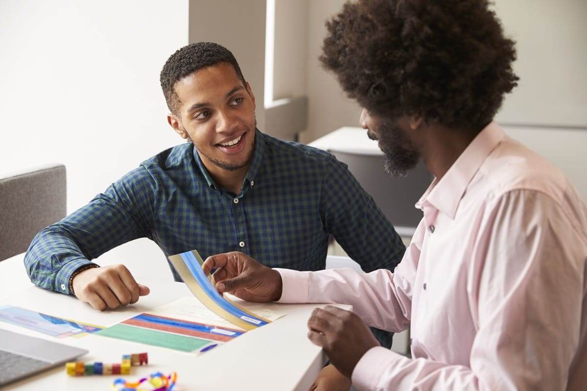 adjustments-for-exams Teenager getting help with dyslexic aids from adult