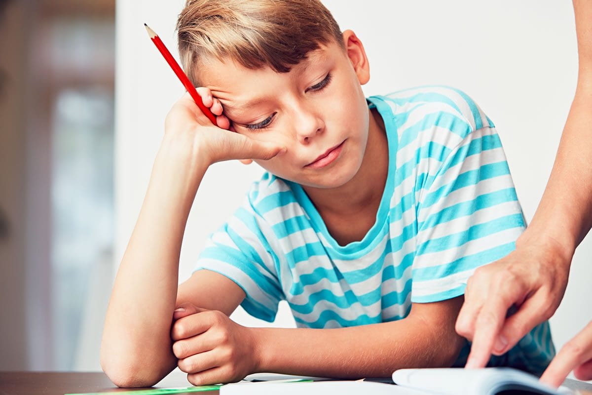 boy-doing-homework-with-an-adult-helping boy doing homework with an adult helping