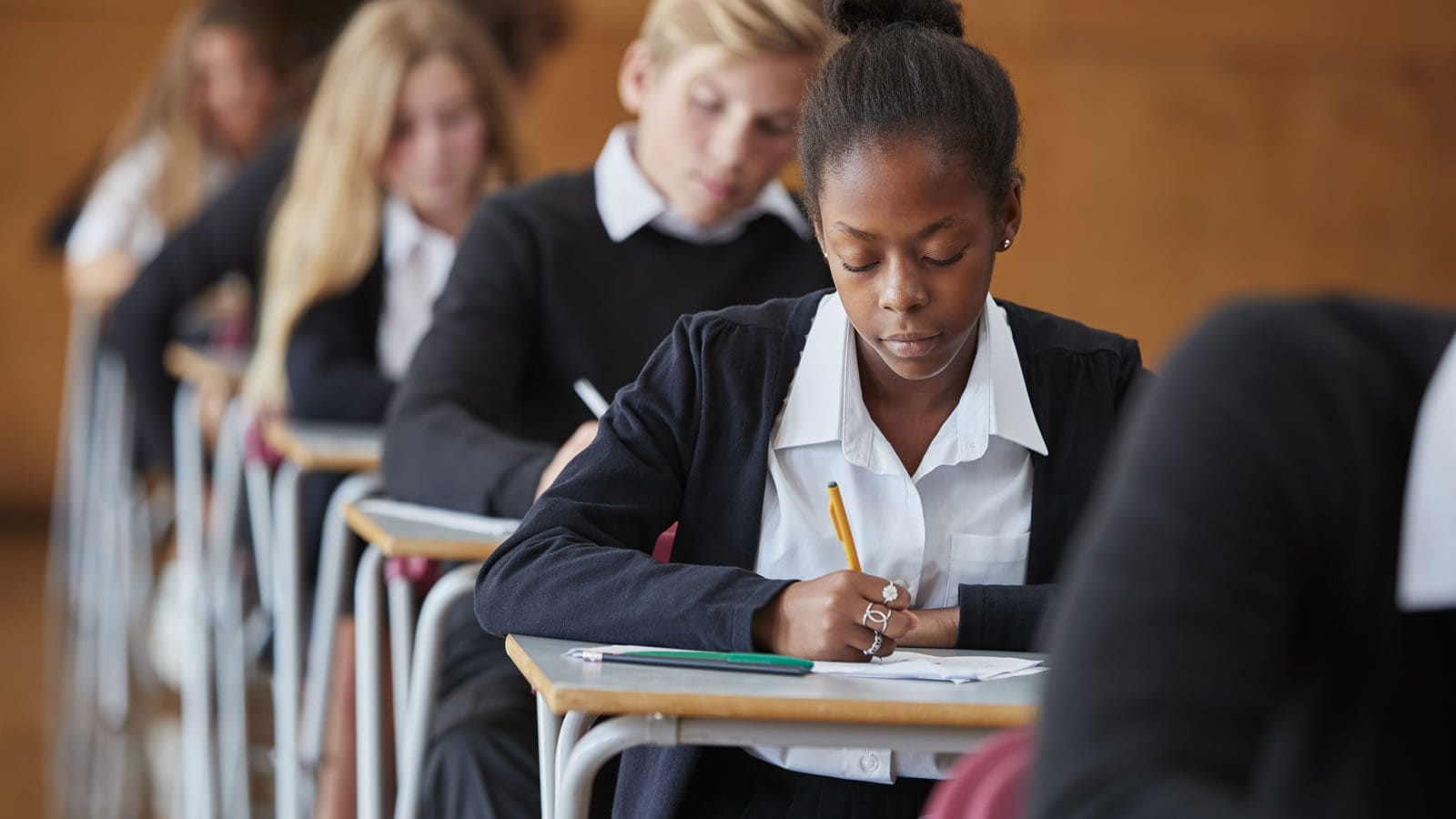 student-in-exam Teenage Students In Uniform Sitting Examination In School Hall